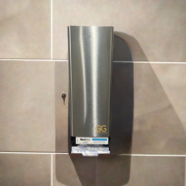 The SD5000SS - Stainless steel, dual tampon and sanitary napkin dispenser by Golden Group International. Shown in use mounted on a tiled restroom wall, Lockable cabinet, wall mountable for use in public restrooms to provide
