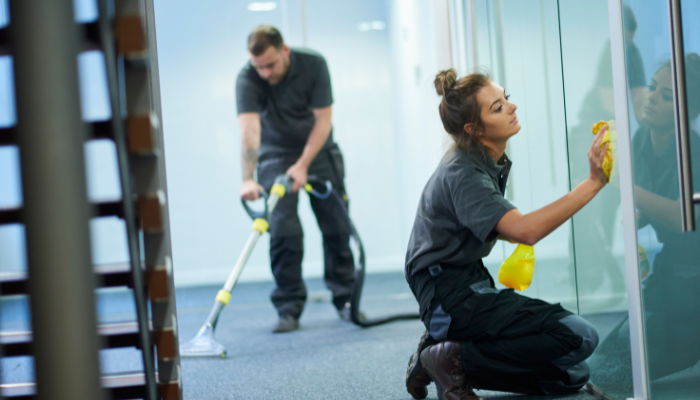 Professional cleaning crew servicing a modern commercial office space