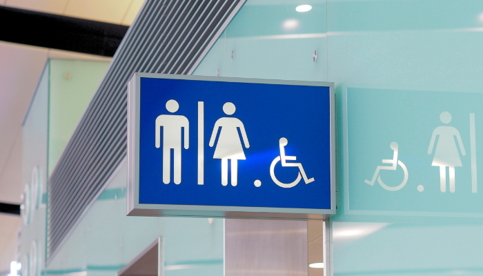 Public restroom sign highlighting modern hygiene standards