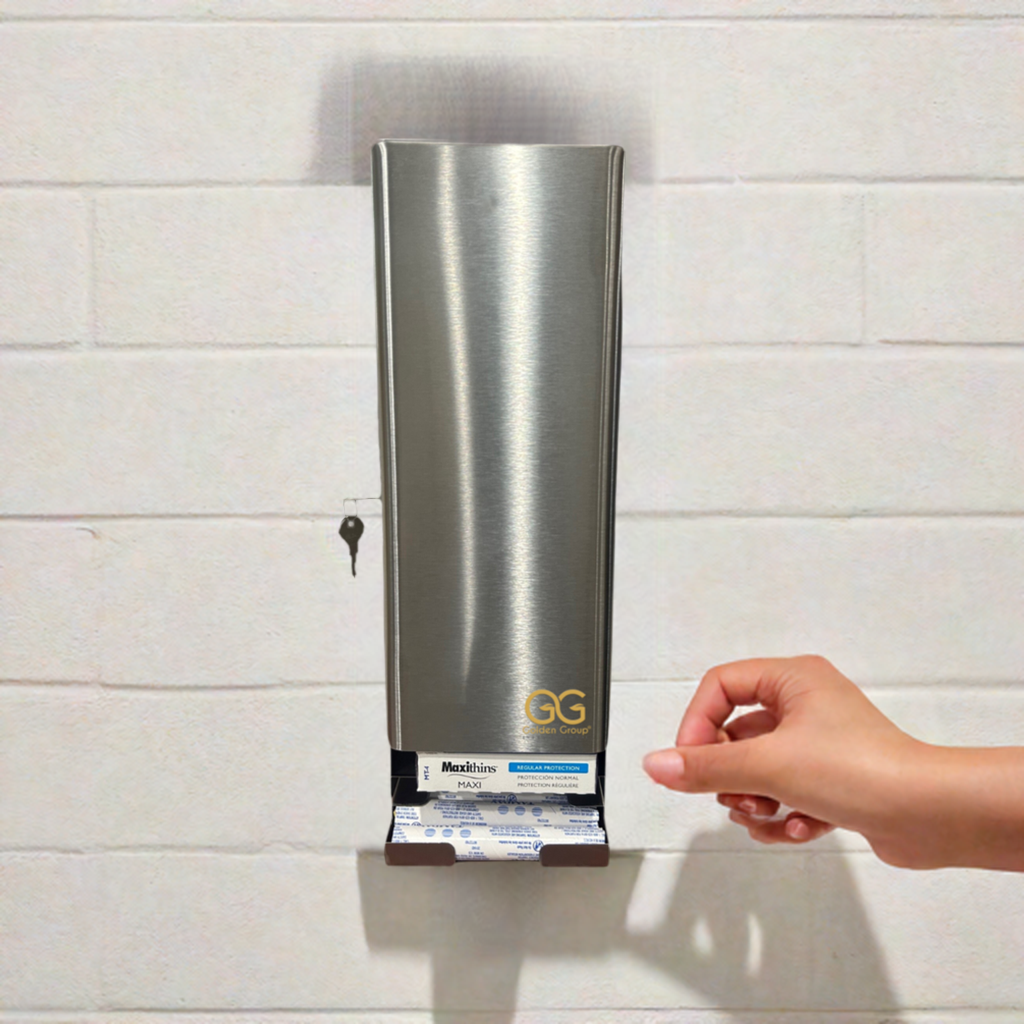 The SD5000SS - Stainless steel, dual tampon and sanitary napkin dispenser by Golden Group International. Shown in use mounted on a restroom wall, Lockable cabinet, wall mountable for use in public restrooms to provide "Free" mentrual care products; made in the USA