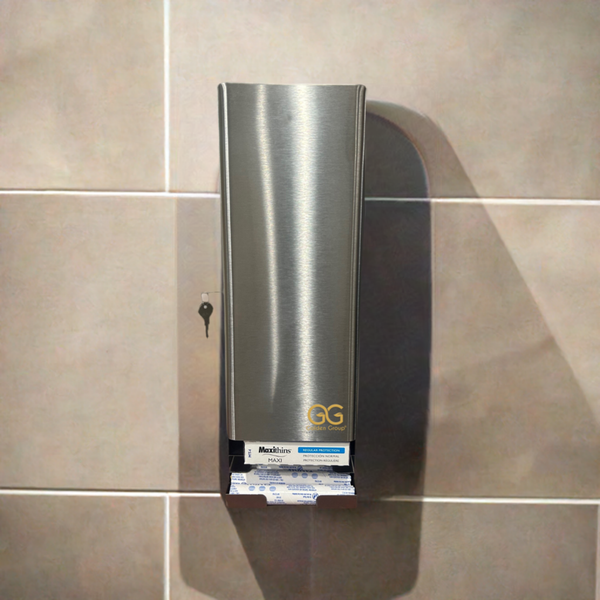 The SD5000SS - Stainless steel, dual tampon and sanitary napkin dispenser by Golden Group International. Shown in use mounted on a tiled restroom wall, Lockable cabinet, wall mountable for use in public restrooms to provide 